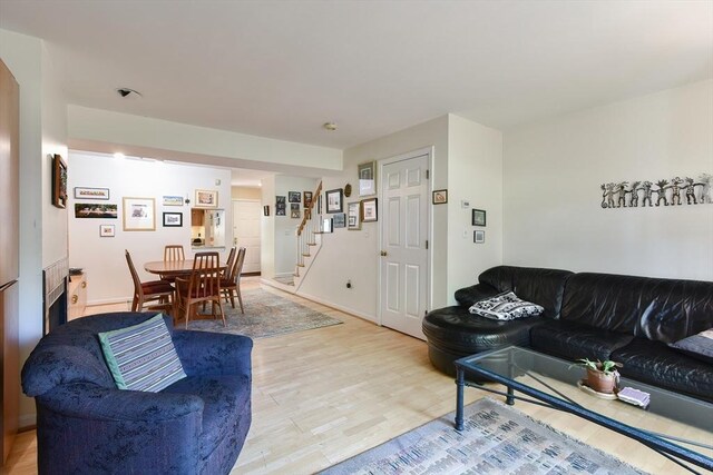 living room with stairway and light wood finished floors