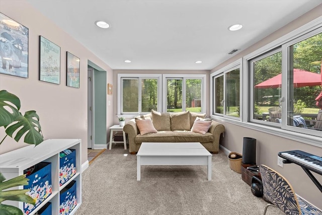 sunroom featuring plenty of natural light, carpet floors, baseboards, and recessed lighting