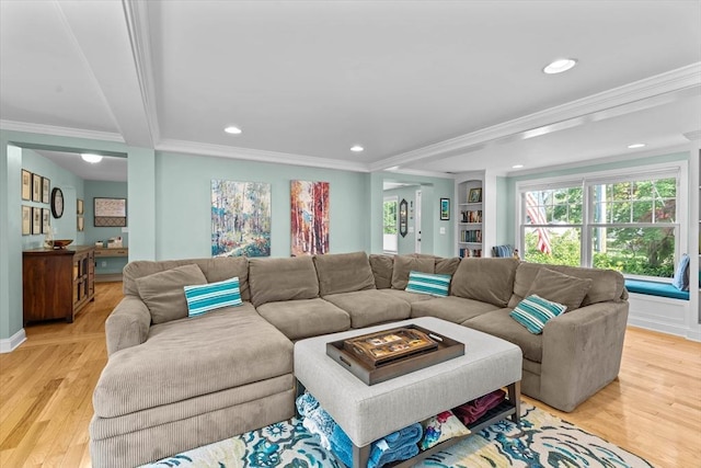 living room with ornamental molding, recessed lighting, and light wood-type flooring