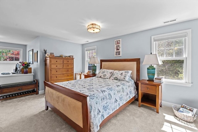 carpeted bedroom with multiple windows and baseboards