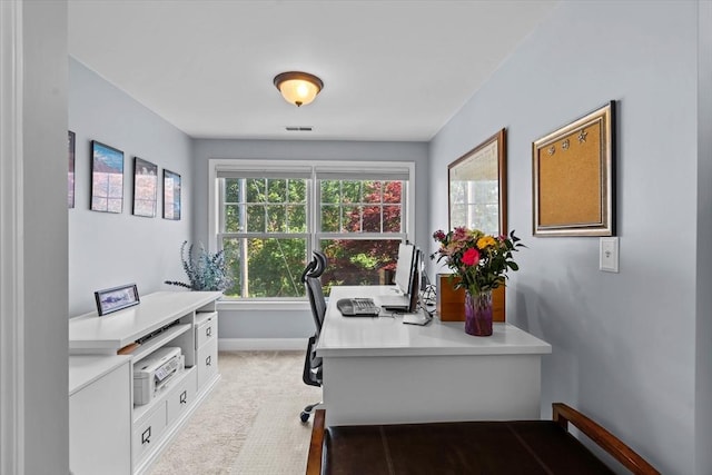 office space with light carpet and baseboards