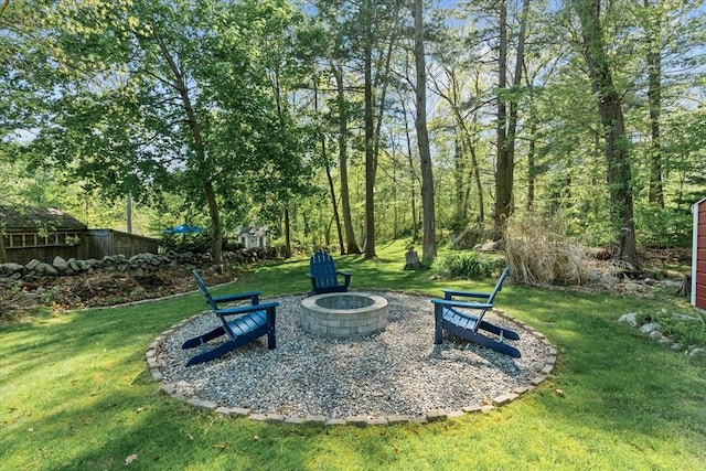 view of grassy yard featuring a fire pit