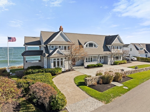 view of front of home with a water view