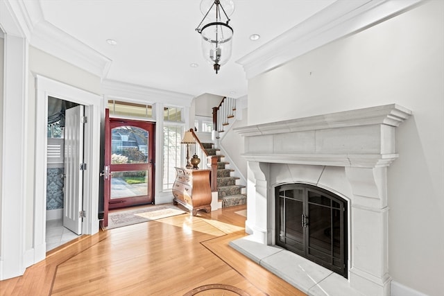 unfurnished living room featuring crown molding and light hardwood / wood-style flooring