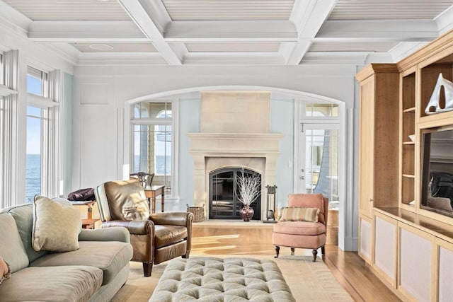 21 Circuit Ave, Scituate, MA 02066 - living area with light wood-style floors, coffered ceiling, a water view, arched walkways, and a premium fireplace
