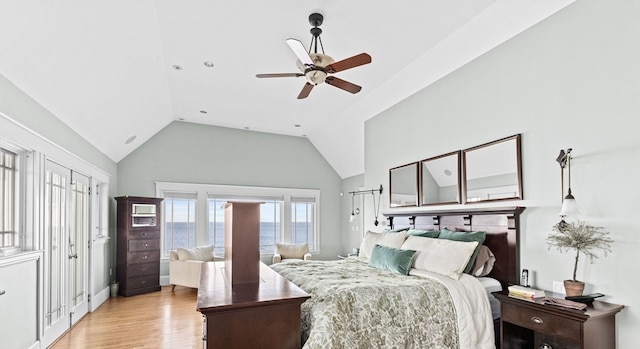 bedroom with ceiling fan, light wood-type flooring, and high vaulted ceiling