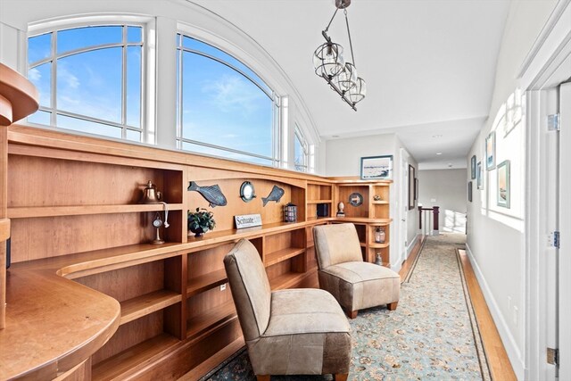 sitting room with lofted ceiling