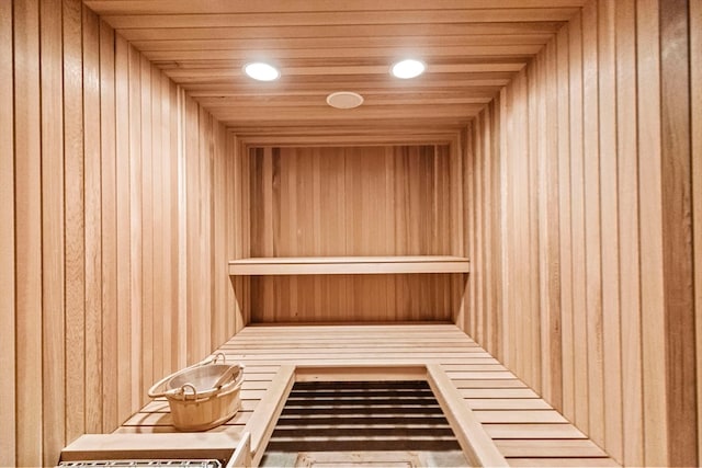 view of sauna featuring wood walls and wood ceiling