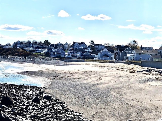 exterior space with a beach view and a water view