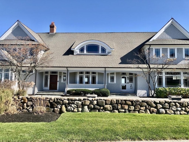 21 Circuit Ave, Scituate, MA 02066 - shingle-style home featuring a chimney, a porch, a front yard, and roof with shingles