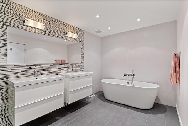 45 Pound St, Medfield, MA 02052 - bathroom featuring two vanities, tile walls, a freestanding bath, tile patterned floors, and recessed lighting