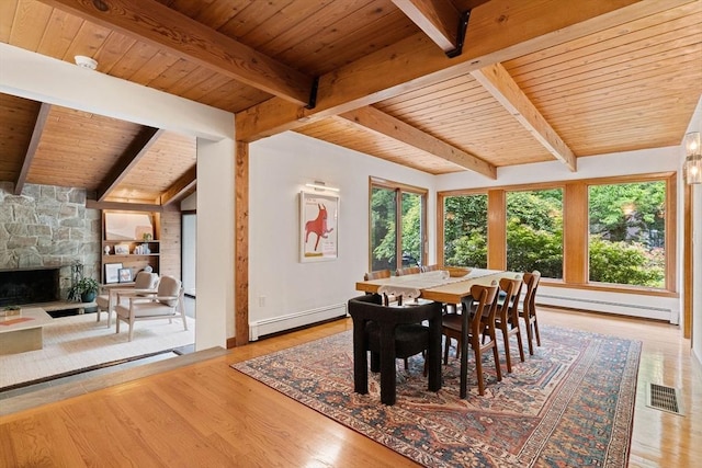 45 Pound St, Medfield, MA 02052 - dining space with a baseboard heating unit, wooden ceiling with exposed beams, a baseboard radiator, wood finished floors, and a fireplace