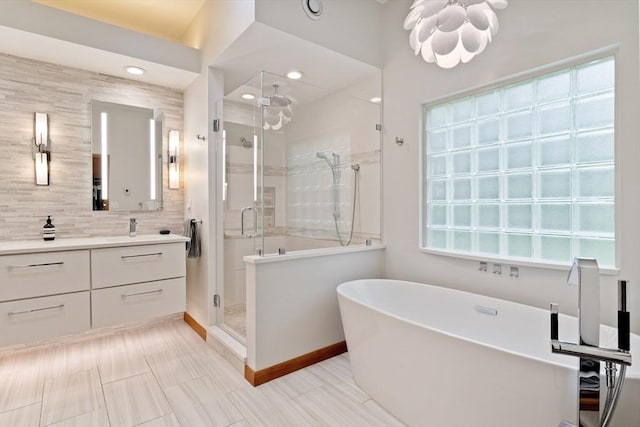 45 Pound St, Medfield, MA 02052 - bathroom featuring a shower stall, vanity, tasteful backsplash, and a freestanding bath