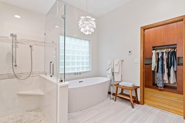 45 Pound St, Medfield, MA 02052 - bathroom featuring a shower stall, a freestanding tub, and a chandelier