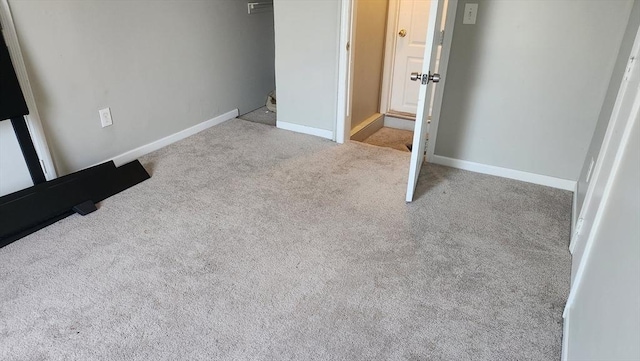 unfurnished bedroom with baseboards and carpet flooring