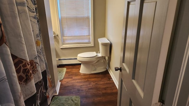 bathroom with curtained shower, wood finished floors, toilet, a baseboard heating unit, and baseboards