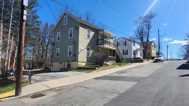 view of street featuring street lights, curbs, and sidewalks