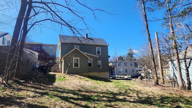 rear view of house with a residential view and a chimney