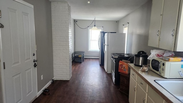 kitchen with light countertops, dark wood-type flooring, white appliances, and ornate columns