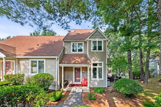 traditional-style house with a shingled roof