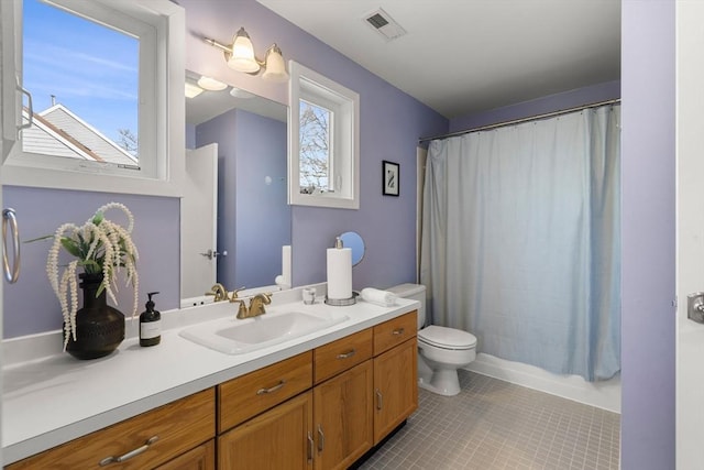 full bath with visible vents, toilet, a shower with shower curtain, tile patterned flooring, and vanity