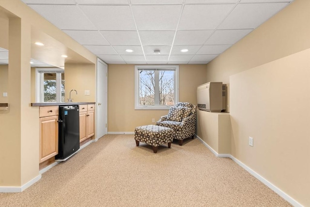 sitting room featuring recessed lighting, baseboards, and light colored carpet