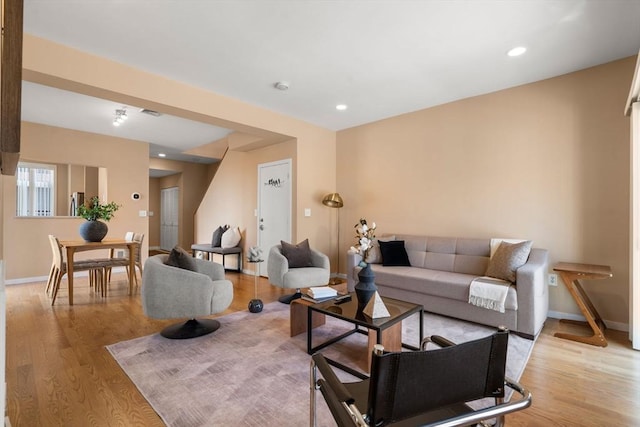 living area with recessed lighting, baseboards, and light wood-style floors