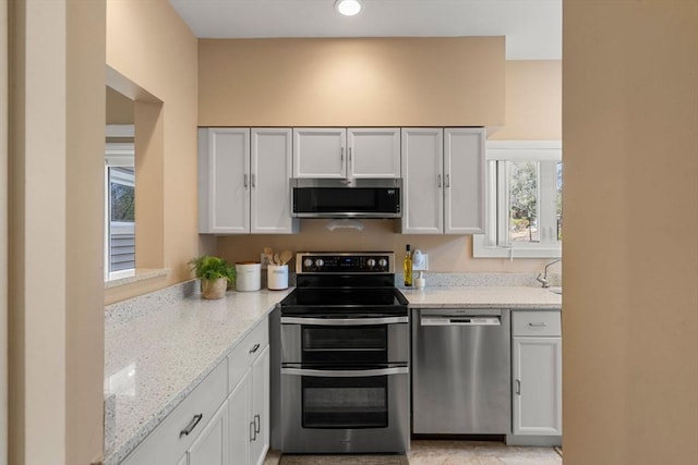 kitchen featuring light stone counters and appliances with stainless steel finishes