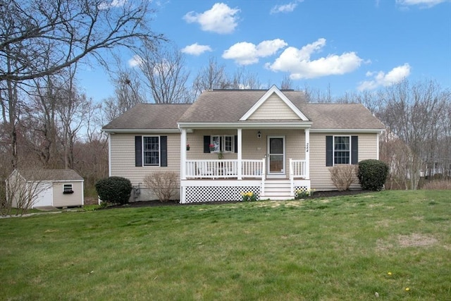 284 Hortonville Rd, Swansea, MA 02777 - view of front of house with a porch, a storage unit, a front yard, an outbuilding, and roof with shingles