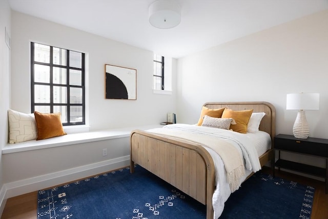 bedroom with dark wood-type flooring