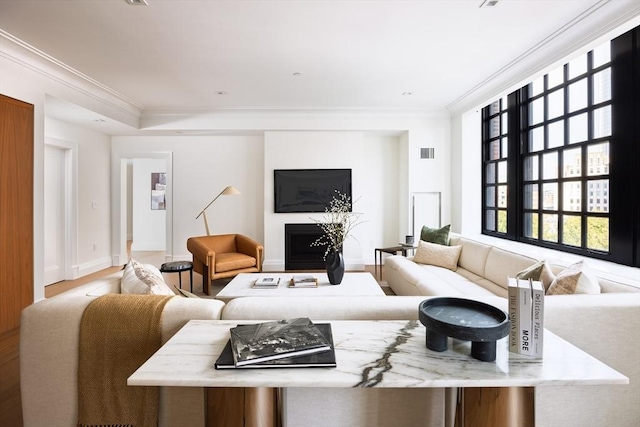 living room with hardwood / wood-style floors and ornamental molding