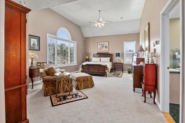 bedroom featuring baseboards, lofted ceiling, light colored carpet, and ceiling fan