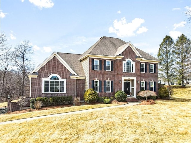 view of front of property with brick siding and a front yard