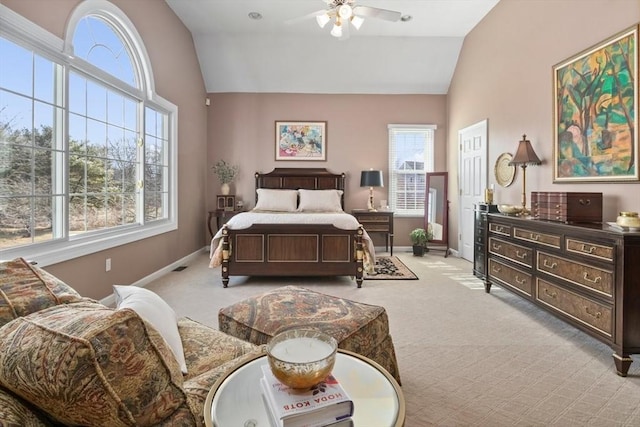 bedroom featuring baseboards, light colored carpet, a ceiling fan, and vaulted ceiling