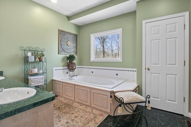 full bathroom with tile patterned flooring, a garden tub, and a sink