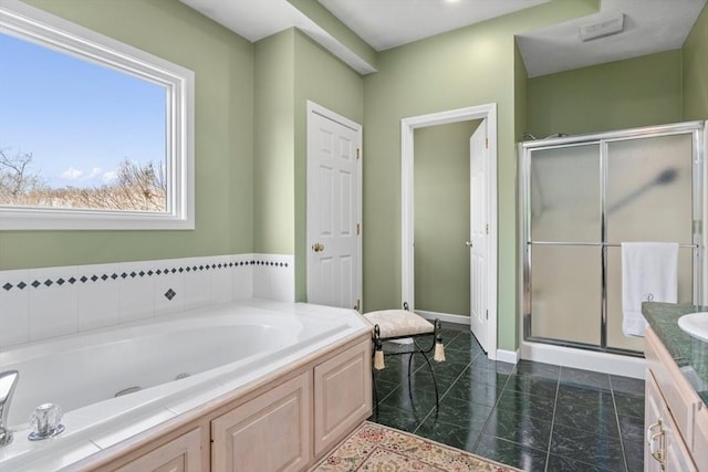 bathroom featuring vanity, a bath, baseboards, and a stall shower