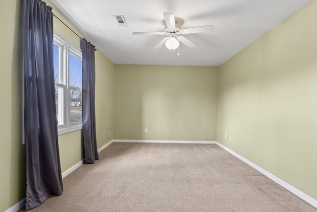 unfurnished room featuring visible vents, baseboards, carpet, and ceiling fan