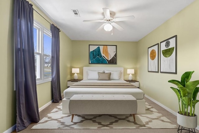 bedroom with baseboards, visible vents, carpet floors, and ceiling fan