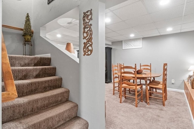 dining area featuring a drop ceiling, recessed lighting, stairway, carpet flooring, and baseboards