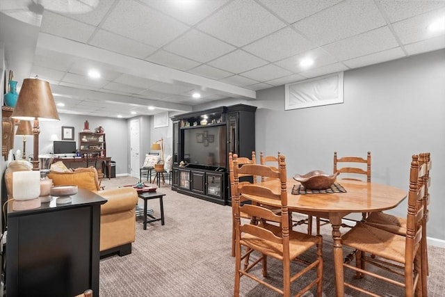 dining room featuring light carpet, a drop ceiling, recessed lighting, and baseboards