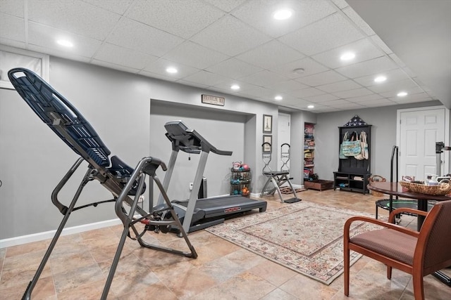 workout room with recessed lighting, baseboards, and a drop ceiling