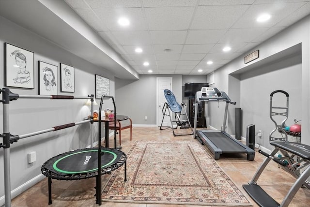 workout room with recessed lighting, a paneled ceiling, and baseboards