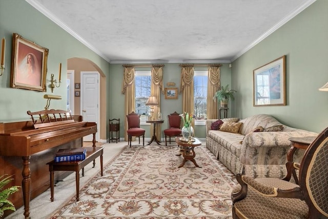 carpeted living room featuring baseboards, arched walkways, a textured ceiling, and crown molding