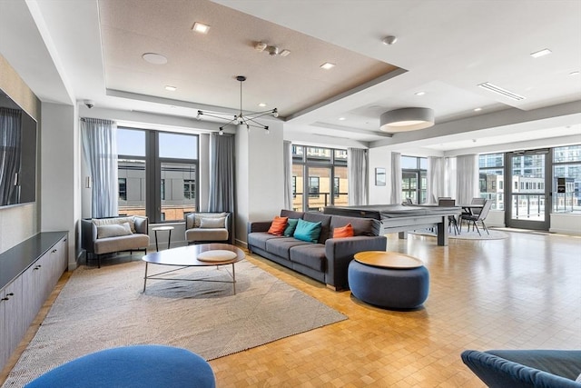 375 Canal St Unit 1109, Somerville, MA 02145 - living area with a tray ceiling, healthy amount of natural light, and a chandelier