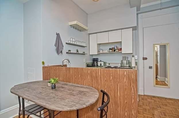 kitchen featuring light parquet flooring and white cabinets