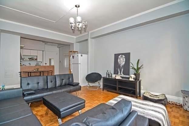 living room featuring parquet floors and a notable chandelier