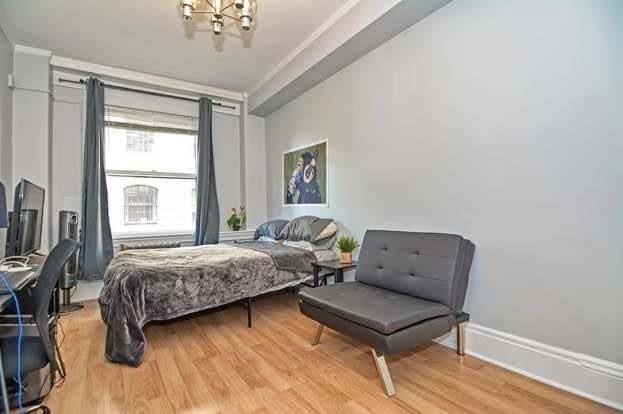 bedroom with a chandelier and light hardwood / wood-style flooring