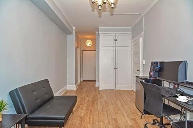 home office with ornamental molding and light hardwood / wood-style floors