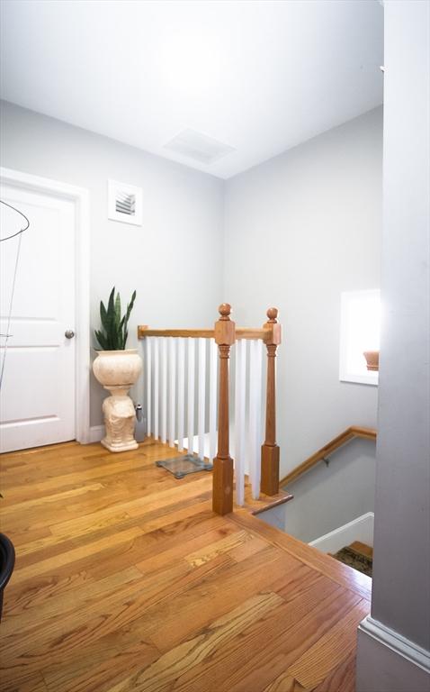 stairway with hardwood / wood-style flooring