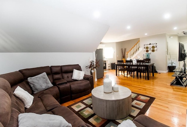 living room with lofted ceiling and hardwood / wood-style floors